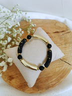 Bracelet noir et doré en tubes acrylique et pierres naturelles d'onyx noir